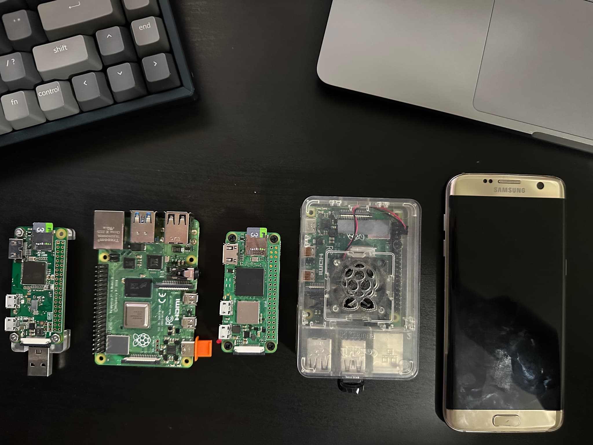 Left to Right. Raspberry pi Zero w with P4wnpi. Raspberry pi 4b 8GB with my Dev Env and other things. Raspberry pi zero 2w - PiSugar with maybe PWNAGOTCHI or IIAB.  Raspberry pi 4b 4GB with IIAB, Next-cloud, Wikipedia, and khan-academy. Samsung galaxy s7 Edge with Kiwix.